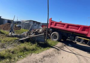 illegal waste dump off red garbage truck