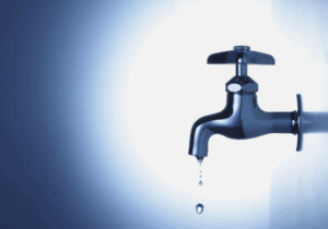 leaking water tap on a dark blue background