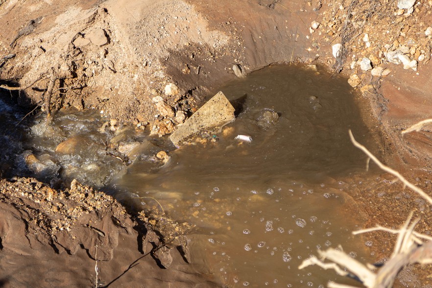 manhole gushes with sewage in an industrial area of Upington.