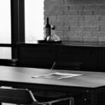paper on boardroom table in black and white photo