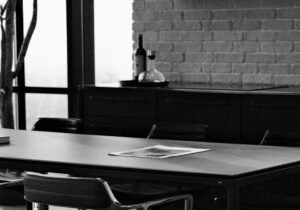 paper on boardroom table in black and white photo