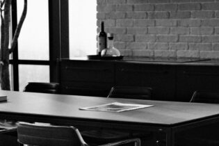 paper on boardroom table in black and white photo