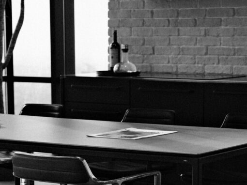 paper on boardroom table in black and white photo
