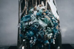 rubbish bin piled with plastic