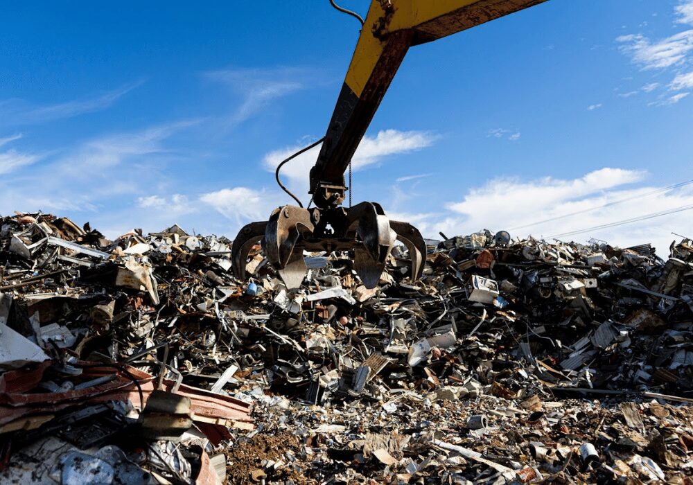 scrap metal recycling in a dump yard with a crane