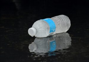 water bottle lying on ground during rain