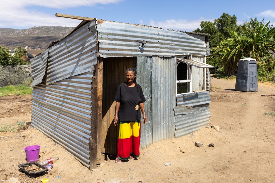 Magdalene Witbooi stands in front of her home in Rastakamp, Citrusdal.