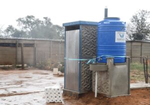 Rand Water Water tank next to outdoor toilet