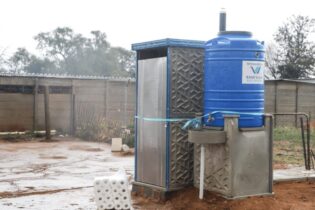 Rand Water Water tank next to outdoor toilet