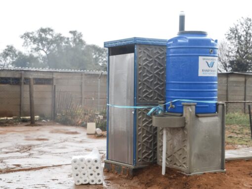 Rand Water Water tank next to outdoor toilet