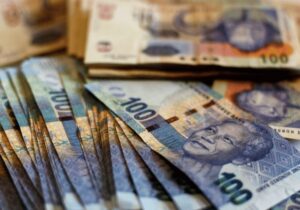 South African hundred rands notes stacked together