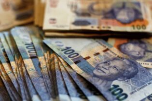 South African hundred rands notes stacked together
