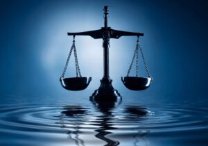 balancing scale ontop of dark blue water