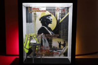 cidb's 2026 ERWIC Awards magazine cover behind a frame