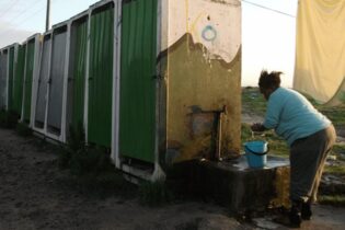 A communal tap in an informal settlement in Cape Town