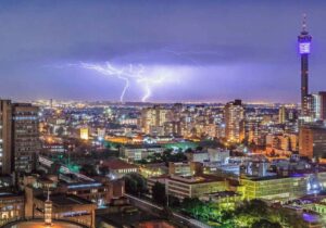 City of Johannesburg with a lightning strike in the background during storm