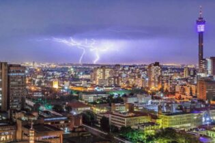 City of Johannesburg with a lightning strike in the background during storm