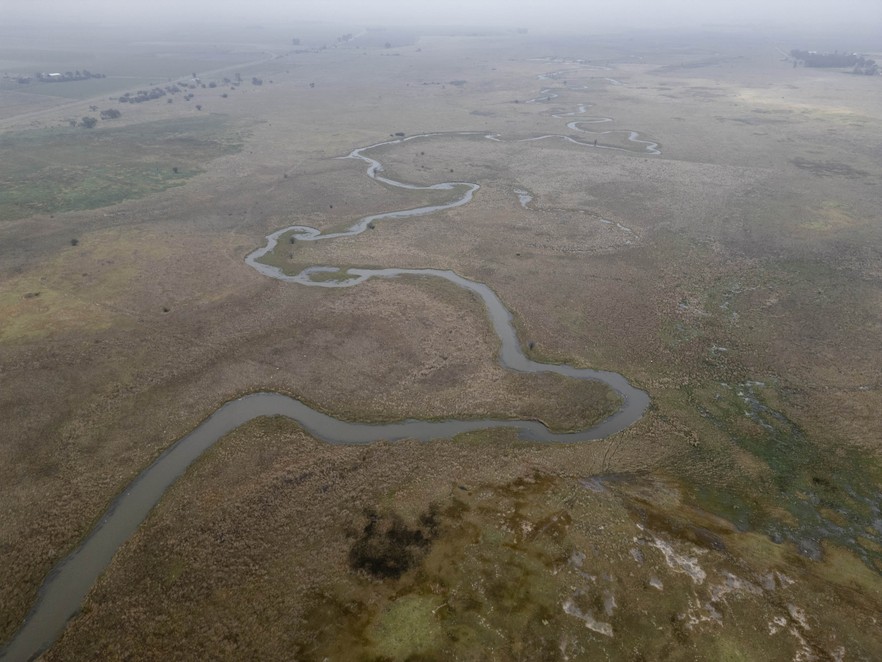 Grey sewage filled water flows down the Harts River after being contaminated by raw sewage from the dysfunctional Sannieshof wastewater treatment plant in the North West town of Sannieshof