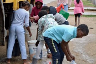 Residents fetch water from a truck in KwaNobuhle, in the Eastern Cape