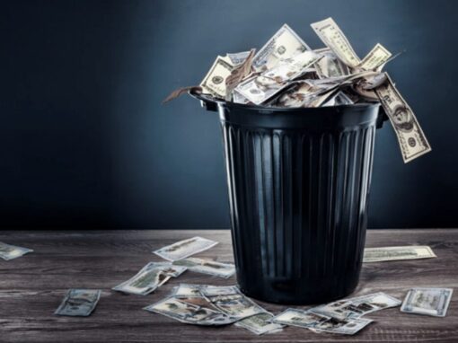 american dollars spilling from a rubbish bin