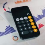 cellphone calculator on top of bar graph calculations