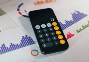 cellphone calculator on top of bar graph calculations