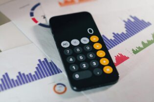 cellphone calculator on top of bar graph calculations