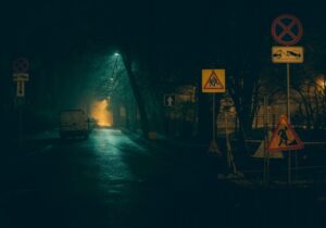 dark street with infrastructure and building signs