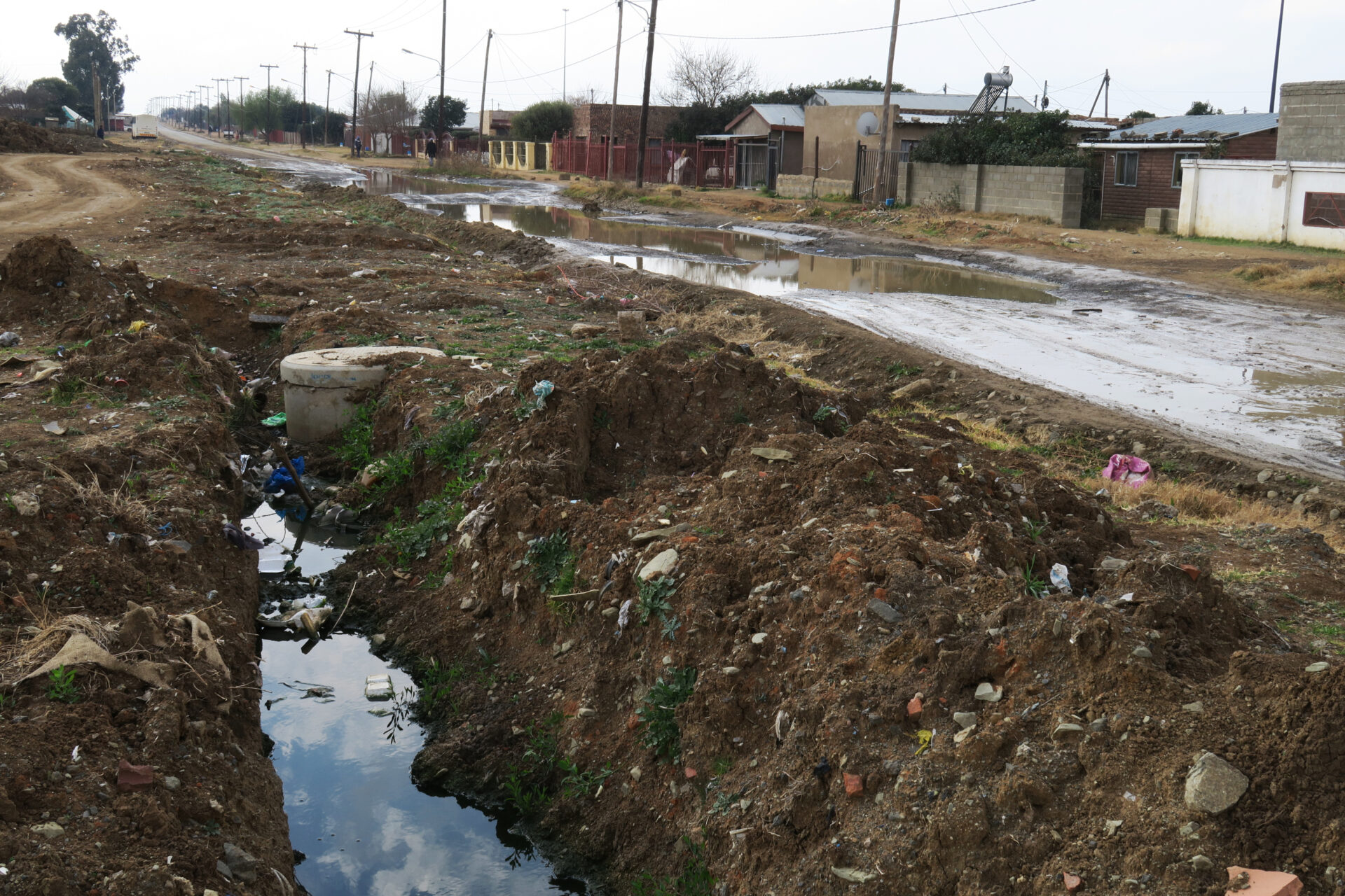 In the midst of the dry season, and despite weeks without rain, clean water floods streets across Bloemfontein, such as this one in Freedom Square in the midst of the city’s south-eastern townships.
