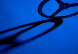 shadow of a cog on a blue background creating a chain like image