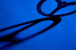 shadow of a cog on a blue background creating a chain like image