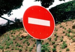 stop sign against a hill backdrop