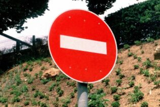 stop sign against a hill backdrop