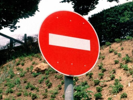 stop sign against a hill backdrop