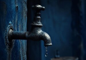 tap running dry in dark blue tones