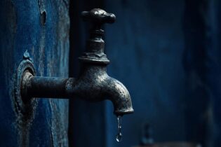 tap running dry in dark blue tones