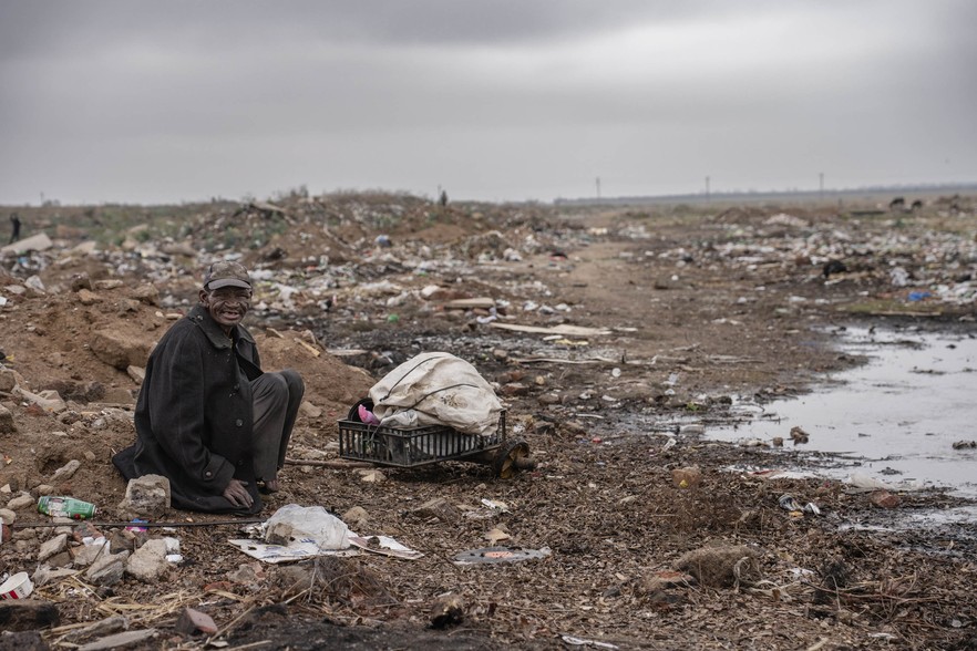 A resident of Agisanang collects recyclable materials from a dump site near Sannieshof.