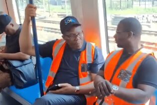 two men sitting on the Durban’s passenger rail service