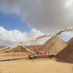 Astec Industries telestack within a sand mound