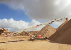 Astec Industries telestack within a sand mound