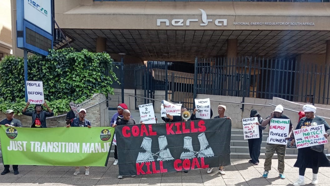 Placards at the Pretoria demonstration highlight community demands for affordable