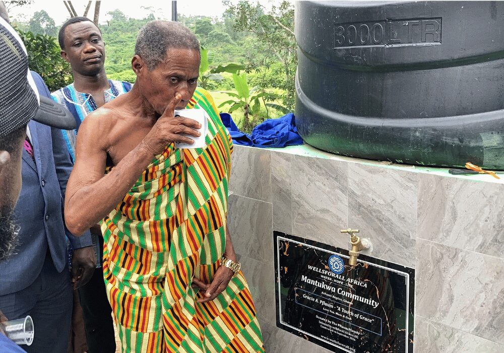 Man drinking water out of a Water Reserve tower