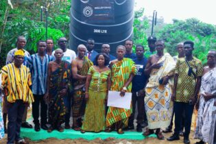 WellsForAll group photo infront of water tower