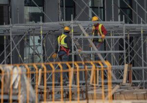construction site with scaffolding and two construction workers
