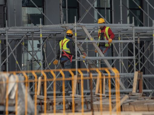 construction site with scaffolding and two construction workers