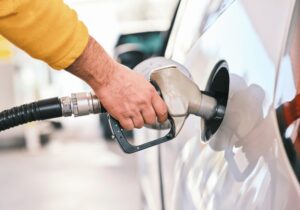 man putting fuel into vehicle