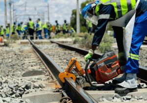 rail construction worker working in a rail with a K1270 rail machine