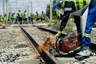 rail construction worker working in a rail with a K1270 rail machine