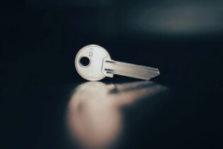 rental housing key isolated on a black background