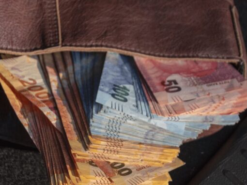 south african rands stacked in a leather wallet